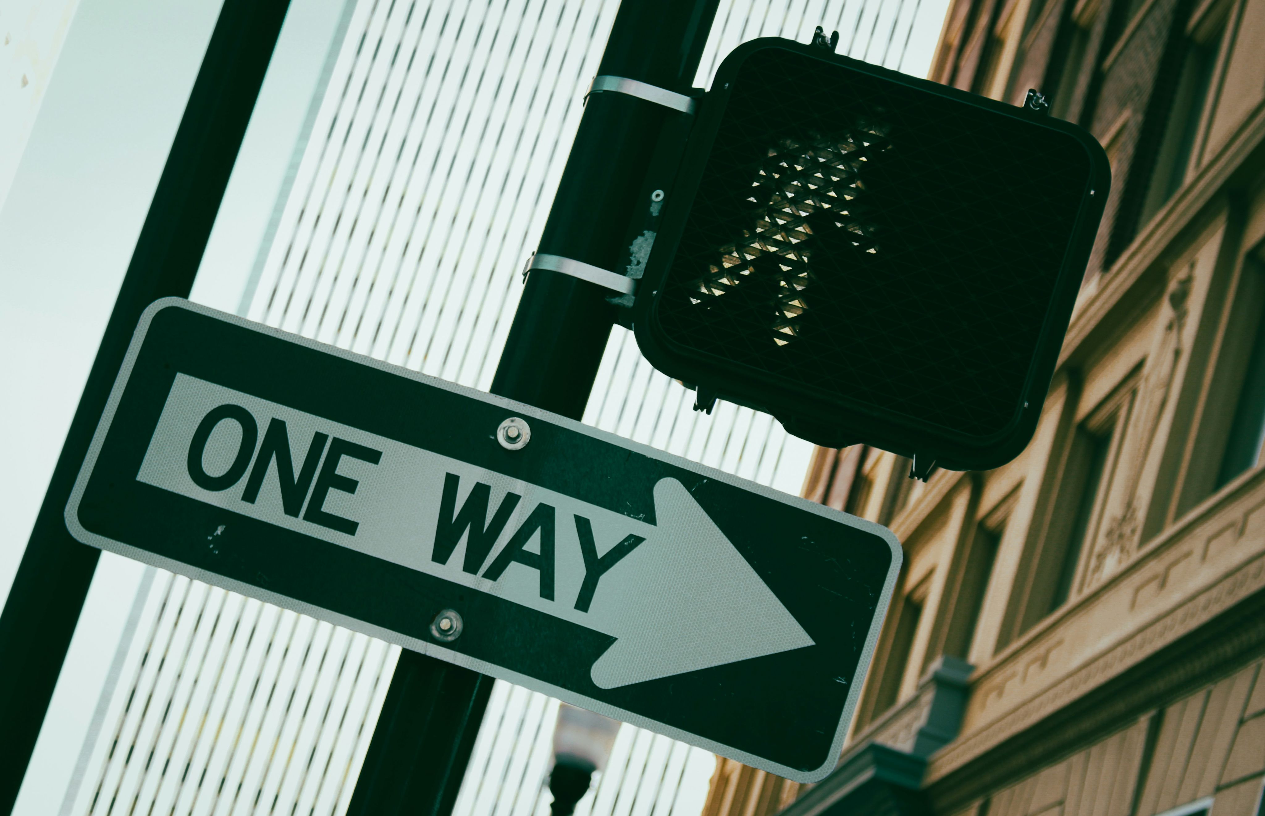 a close up of a street sign in front of a building